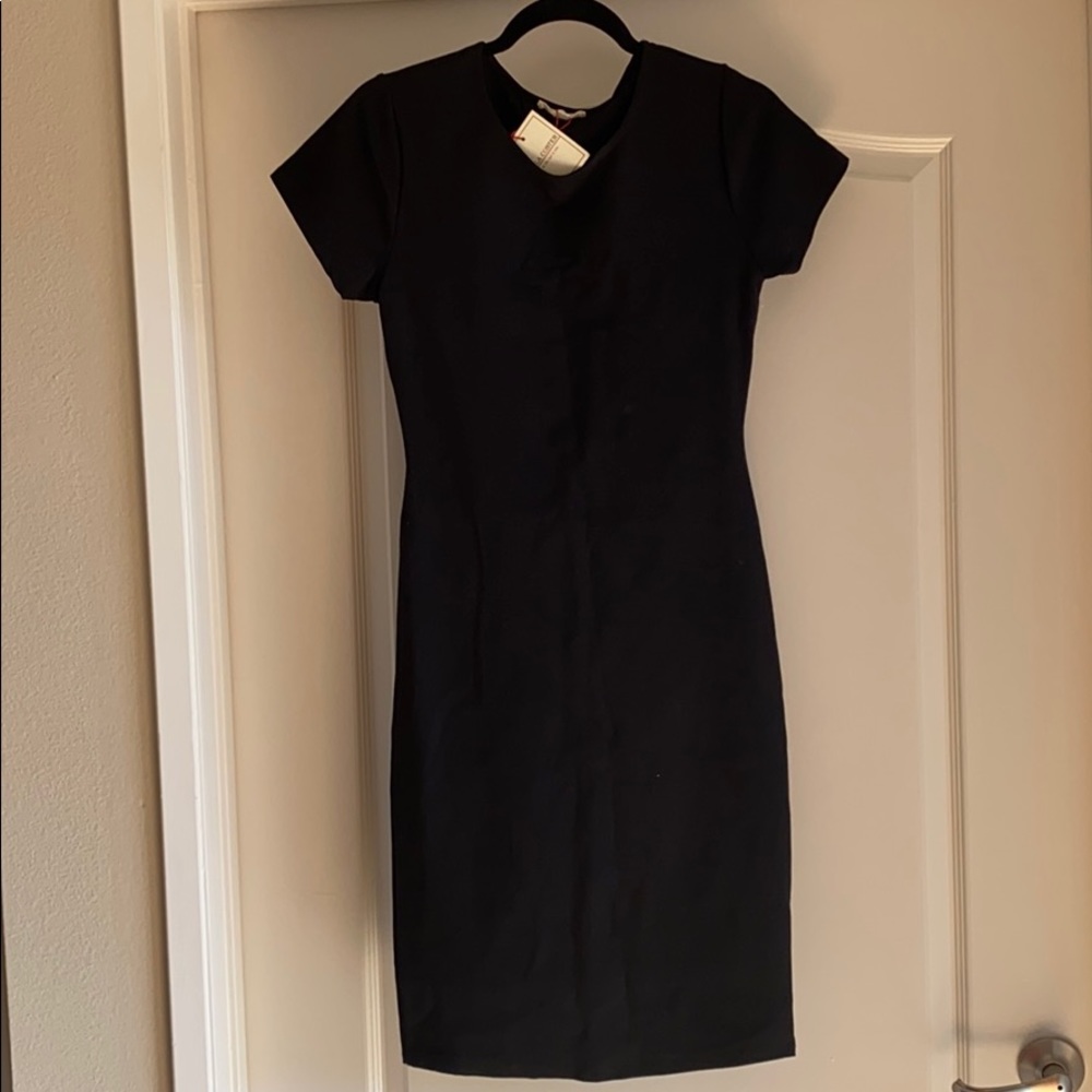 Black form fitting dress with open back